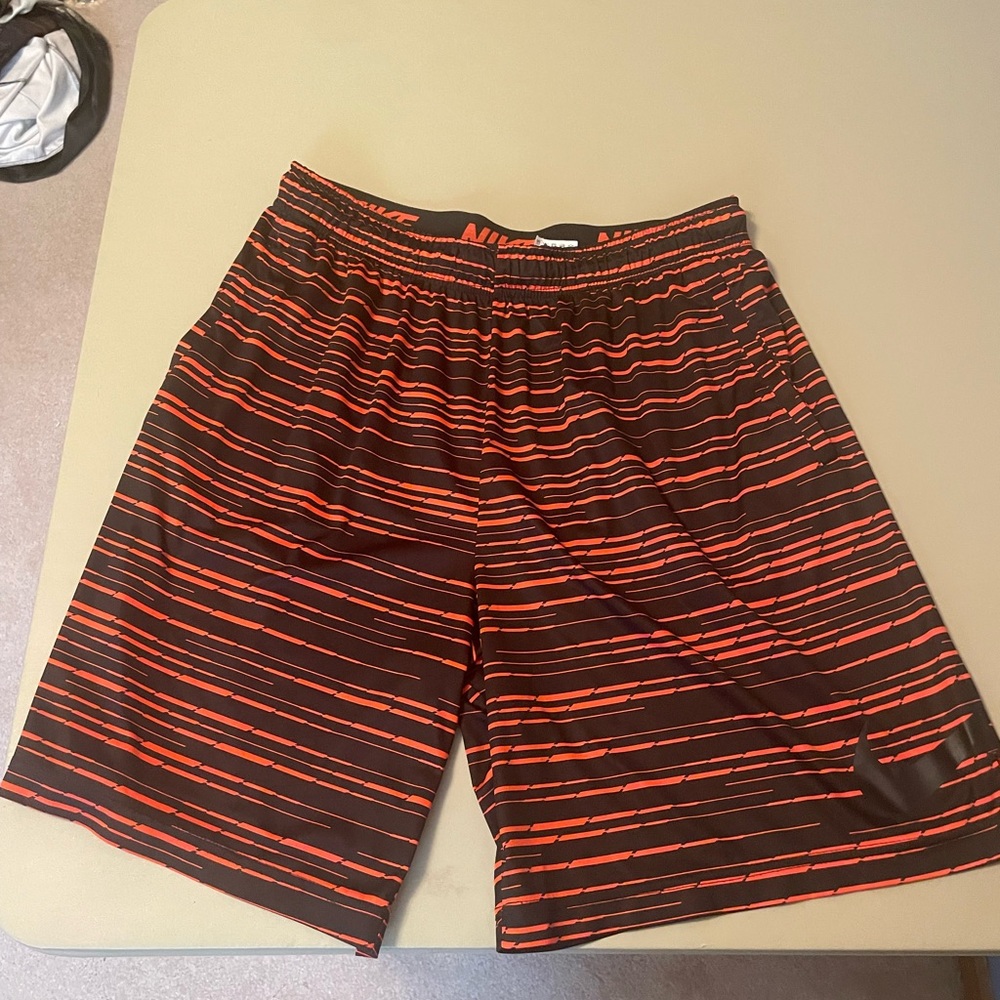 Orange Nike Dri-fit orange abstract jumbo swoosh shorts with drawstrings